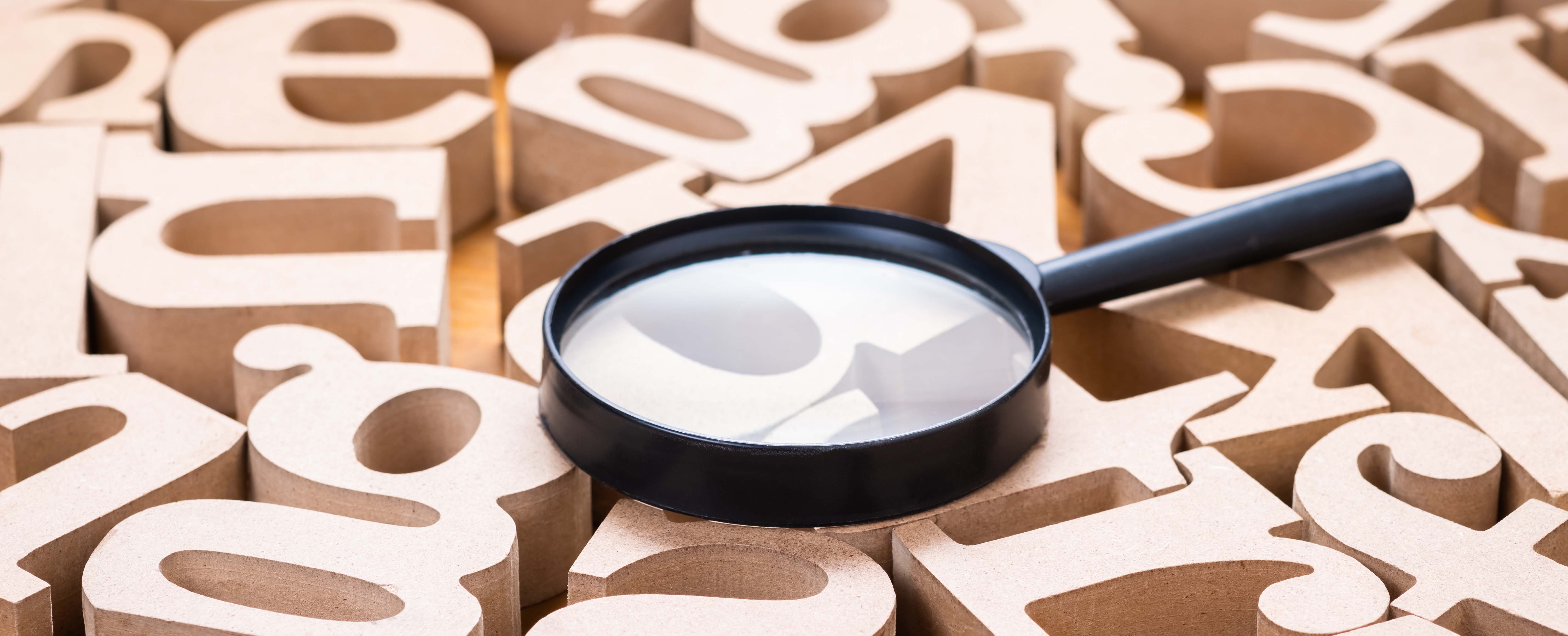 magnifying glass and letters